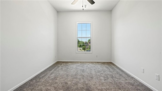 carpeted spare room featuring a ceiling fan, visible vents, and baseboards