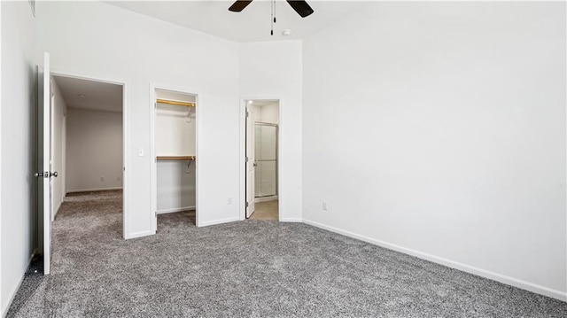 unfurnished bedroom featuring carpet floors, a closet, ceiling fan, and baseboards