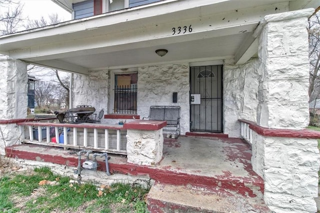 view of exterior entry with covered porch