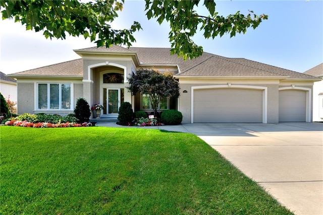 view of front of home featuring a front lawn and a garage