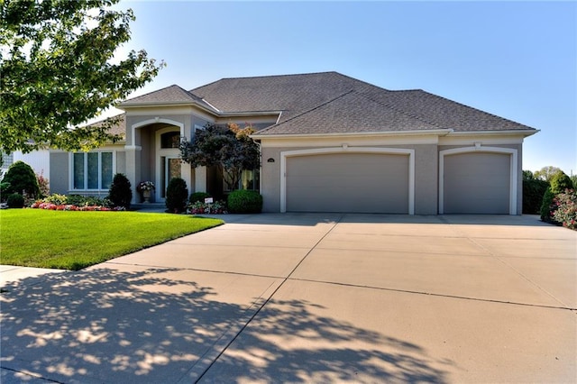 view of front facade featuring a front yard and a garage