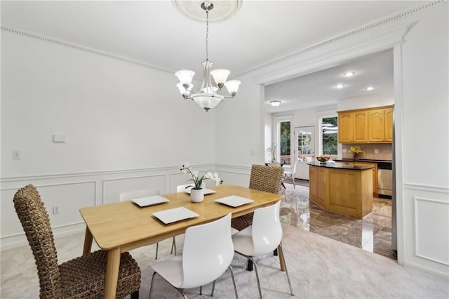 dining space featuring crown molding and a notable chandelier