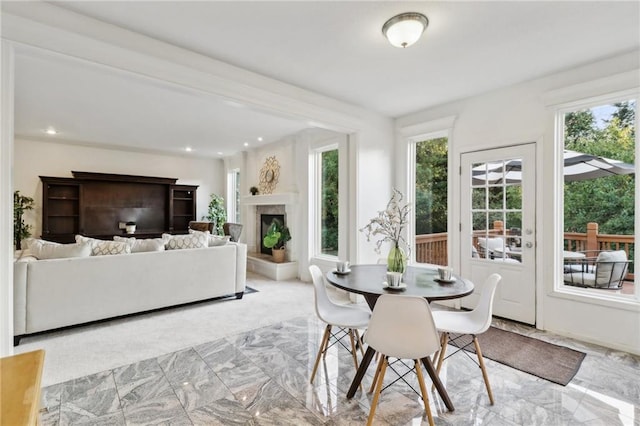 dining room with a high end fireplace