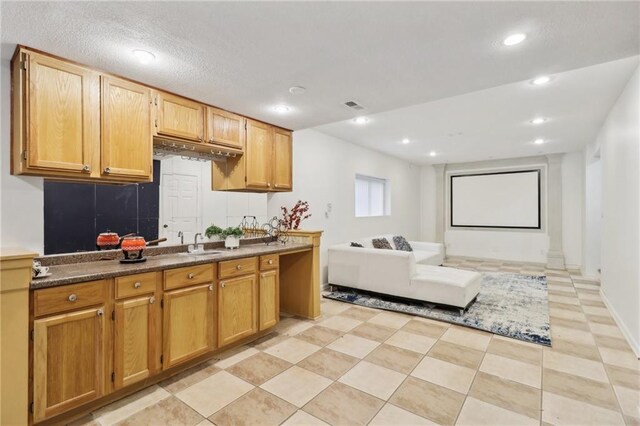 kitchen featuring light tile patterned floors and sink