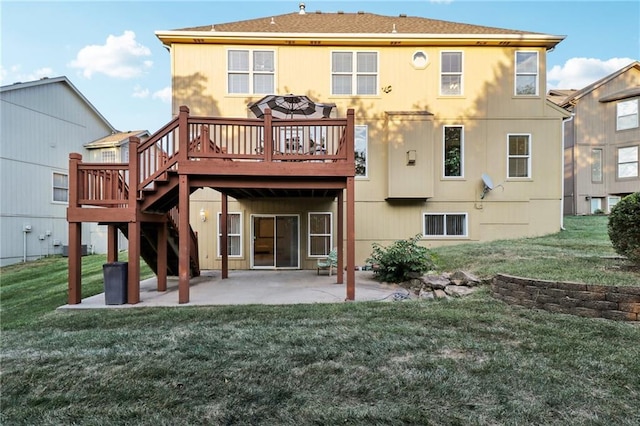 rear view of property featuring a wooden deck, a yard, and a patio area