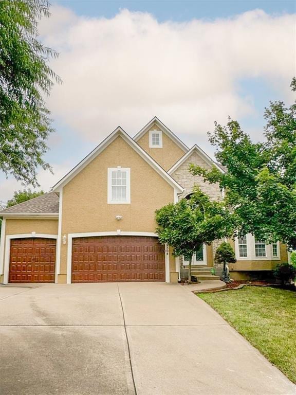 view of front of house with a front yard and a garage