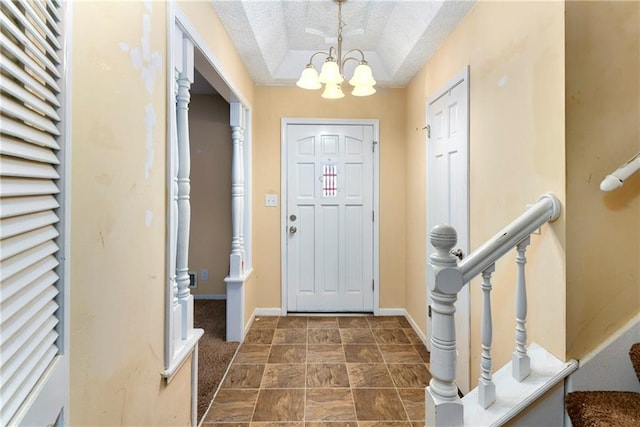 entrance foyer featuring an inviting chandelier and a textured ceiling