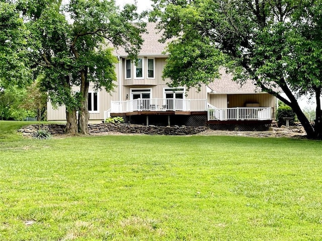 back of property with a lawn and a wooden deck