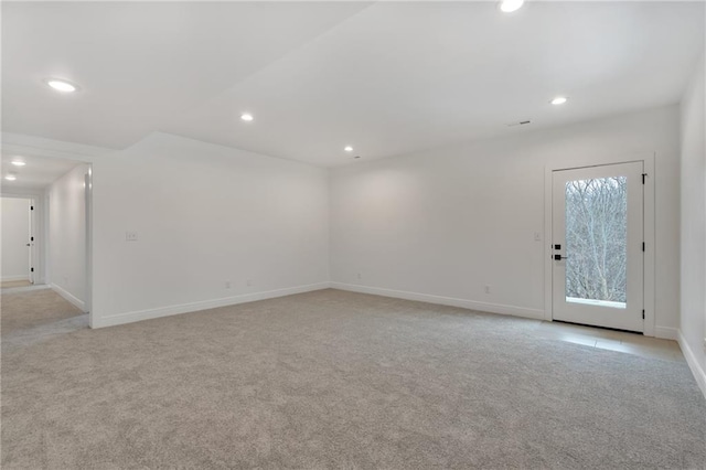 unfurnished room with light carpet, baseboards, and recessed lighting