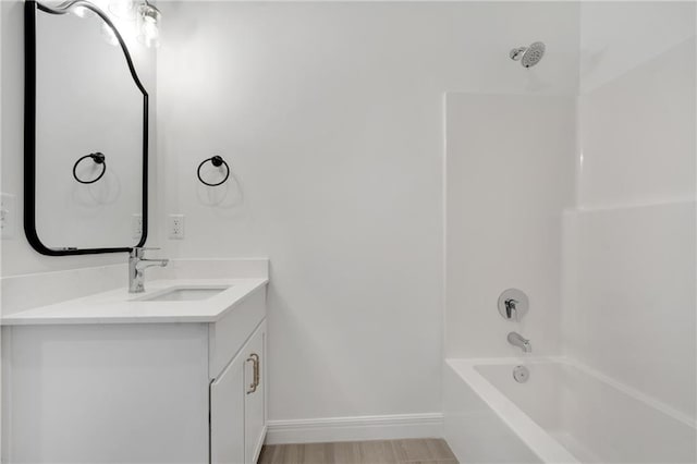 full bathroom featuring baseboards, shower / washtub combination, and vanity