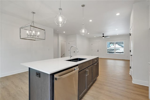 kitchen featuring a sink, light wood-type flooring, light countertops, and dishwasher