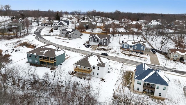 snowy aerial view with a residential view