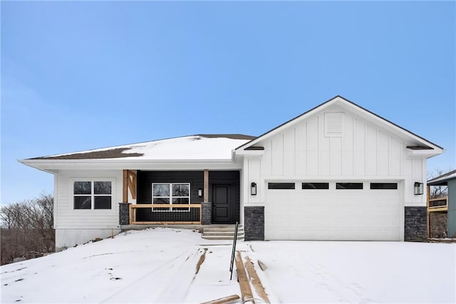 view of front of house with a garage, stone siding, a porch, and board and batten siding