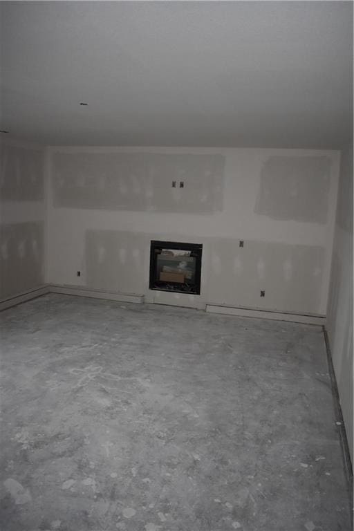 unfurnished living room featuring concrete floors