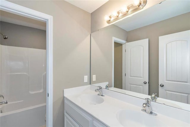 bathroom with washtub / shower combination and vanity