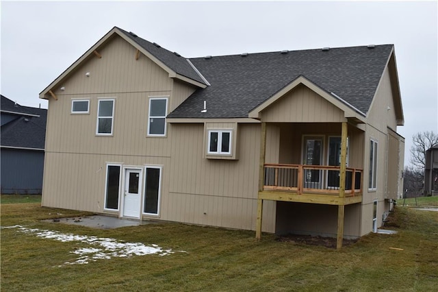 rear view of property with a lawn