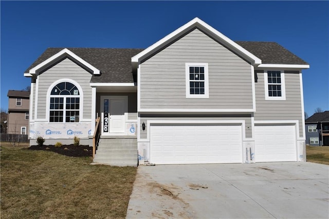 view of front facade featuring concrete driveway, a front lawn, roof with shingles, and an attached garage