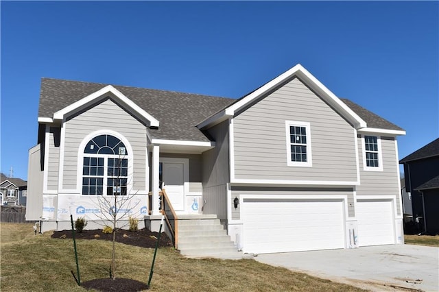 view of front of property with driveway, a shingled roof, and an attached garage