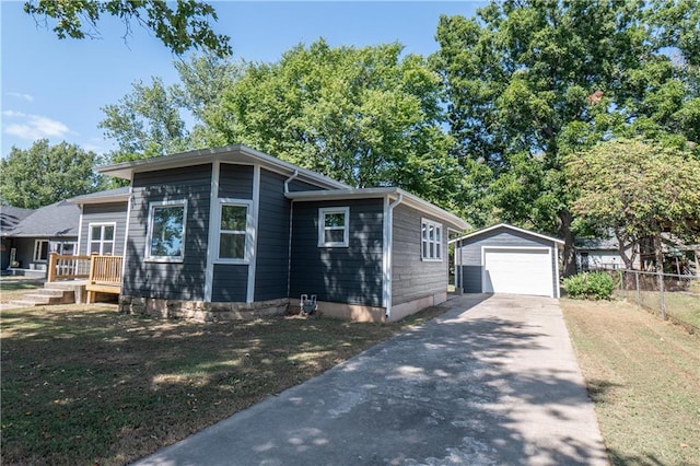 view of front of property with a garage and an outbuilding