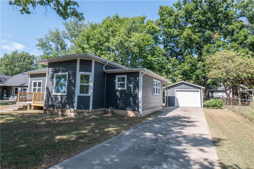 912 Indiana St, Neodesha, KS 66757 - view of front of property with a garage and an outbuilding