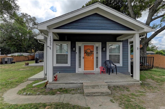 bungalow with a porch and a front yard