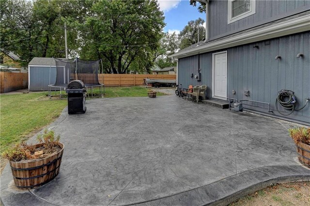 view of patio / terrace with a trampoline and a storage shed