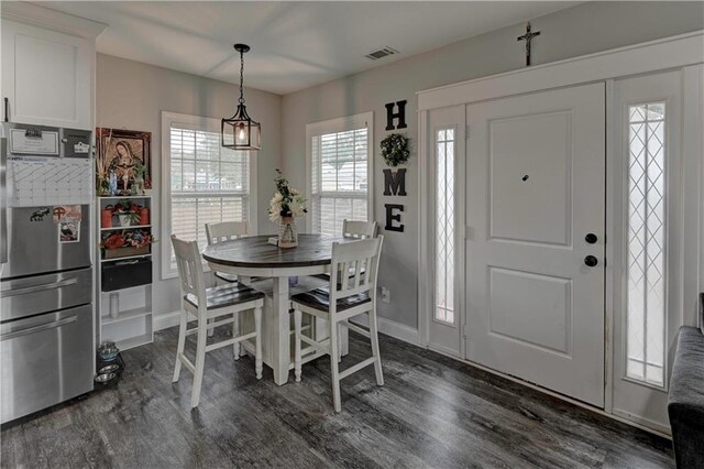 dining space with dark hardwood / wood-style floors