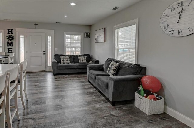 living room featuring dark hardwood / wood-style floors and plenty of natural light