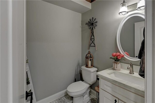 bathroom featuring tile patterned floors, vanity, and toilet