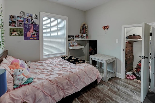 bedroom with wood-type flooring and a closet