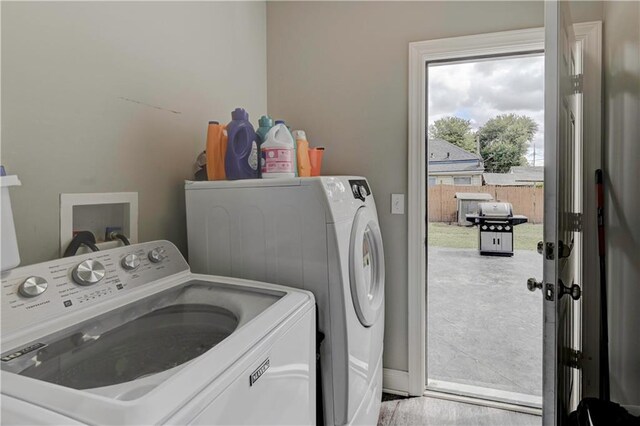 laundry room featuring light wood-type flooring and washing machine and dryer