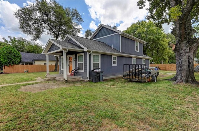 rear view of property featuring a lawn