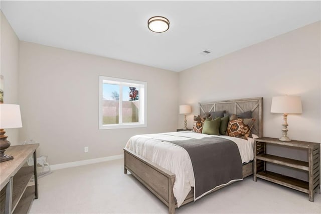 bedroom with baseboards, visible vents, and light colored carpet