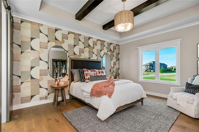 bedroom with ornamental molding, baseboards, beam ceiling, and wood finished floors