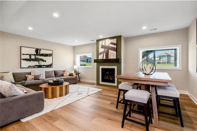 living area with plenty of natural light, visible vents, and light wood-type flooring