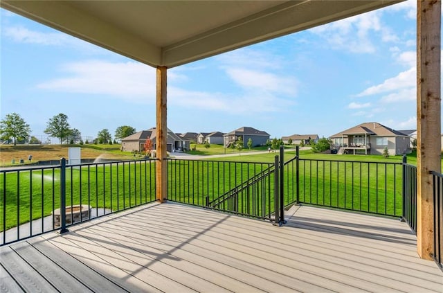 deck featuring a yard and a residential view