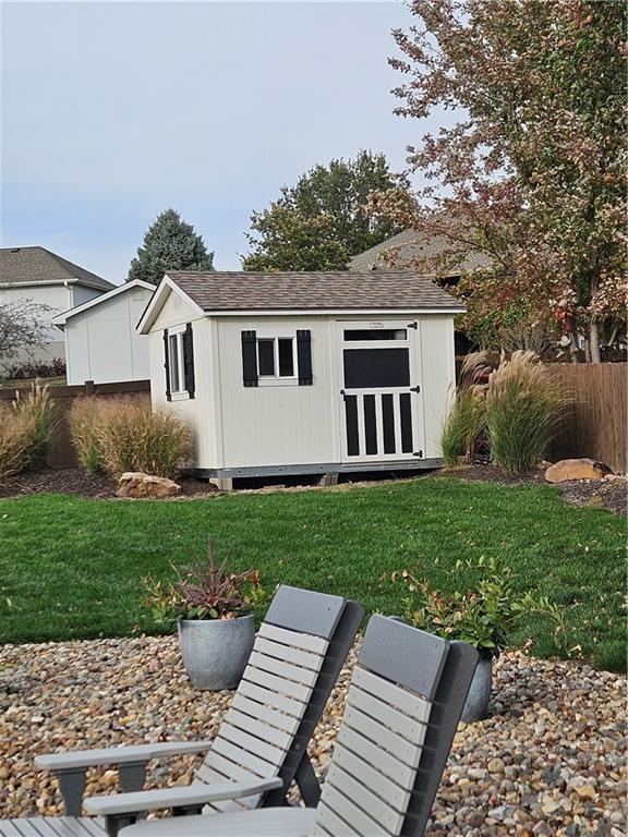 view of shed featuring fence