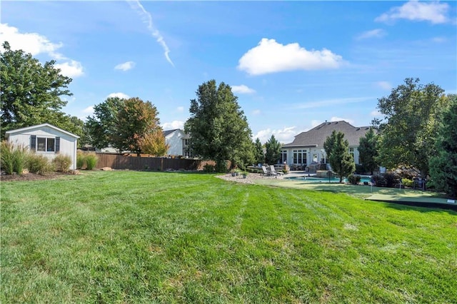 view of yard with fence and an outdoor pool