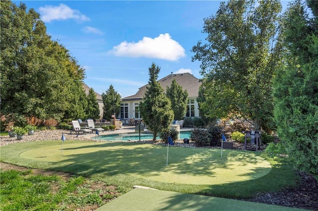 view of yard with an outdoor pool, a patio, and fence