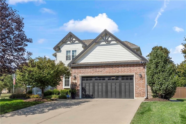 view of front of house featuring an attached garage, brick siding, fence, concrete driveway, and a front yard