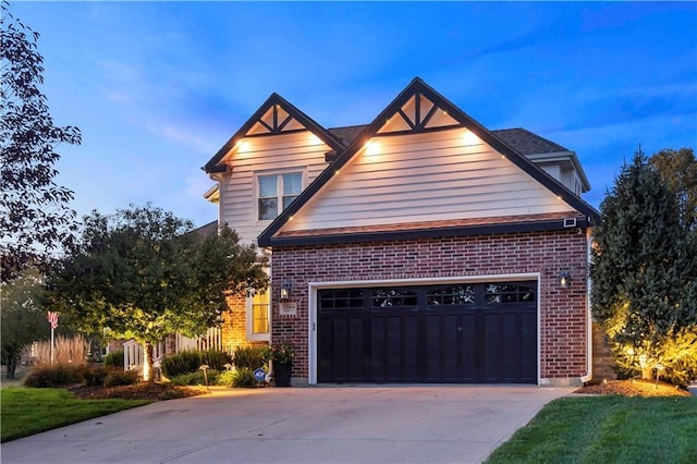 view of front of house featuring a garage, driveway, and brick siding