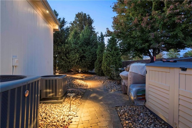 exterior space featuring central air condition unit and fence