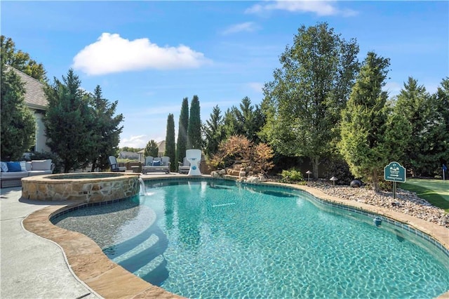 view of pool featuring an in ground hot tub