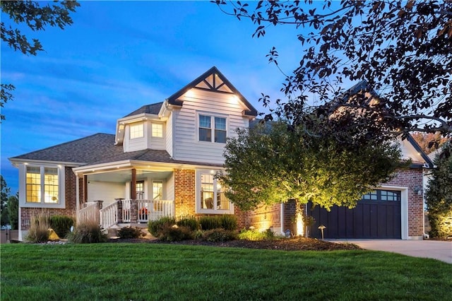 view of front of home featuring driveway, a front lawn, and brick siding