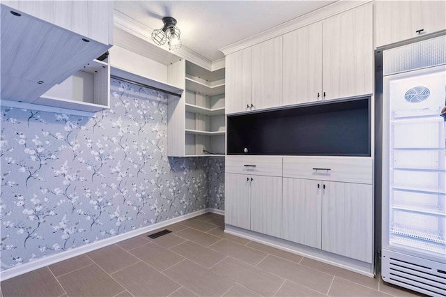 kitchen with wallpapered walls, visible vents, fridge, open shelves, and crown molding