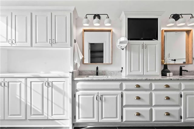 bathroom featuring a sink and double vanity