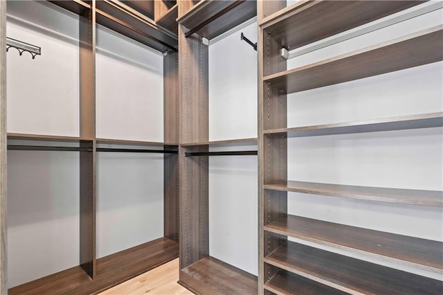 walk in closet featuring wood finished floors