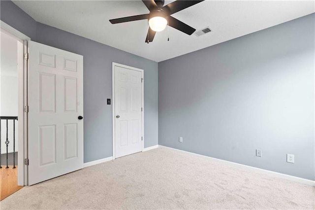 unfurnished bedroom with carpet floors, baseboards, and visible vents