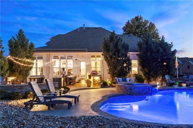 view of pool featuring a patio and a pool with connected hot tub