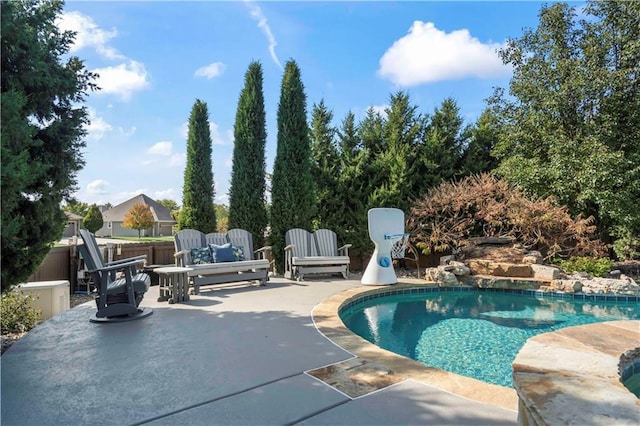 outdoor pool featuring a patio area and fence